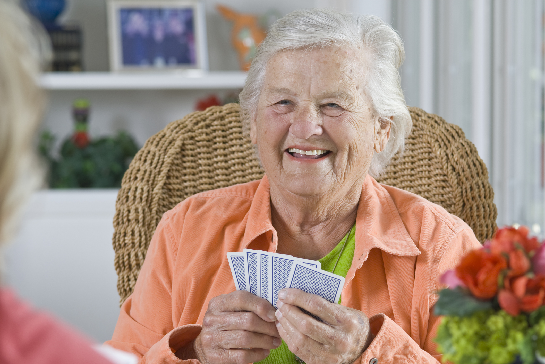 Senior woman smiling while playing cards