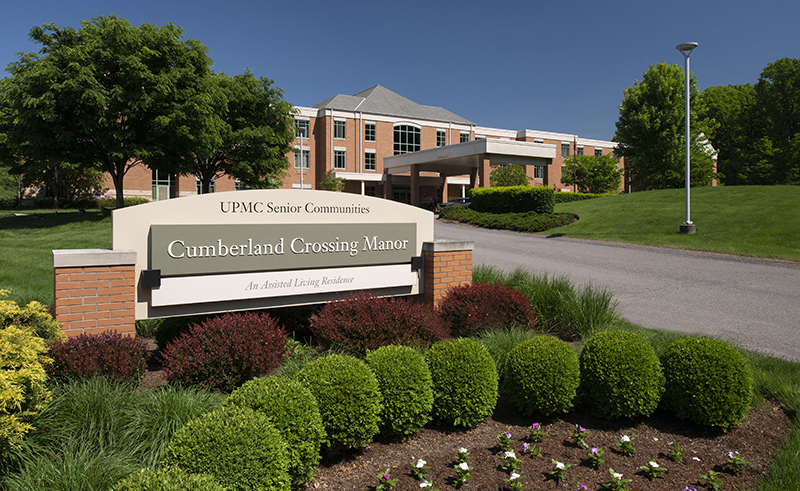 Cumberland Crossing Manor exterior with sign and landscaping.