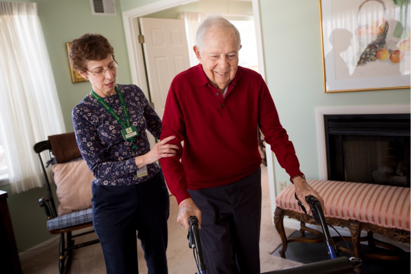 Staff assisting a resident in a home-like setting.