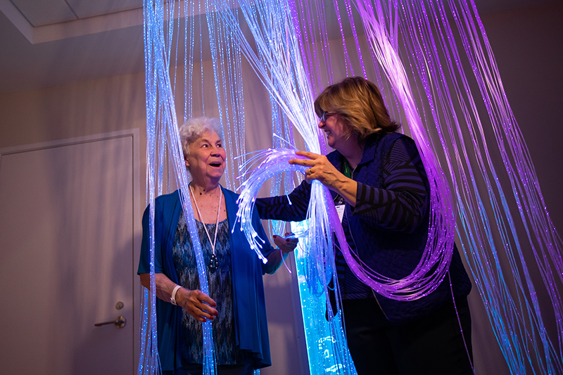Residents enjoying an interactive activity with lights.