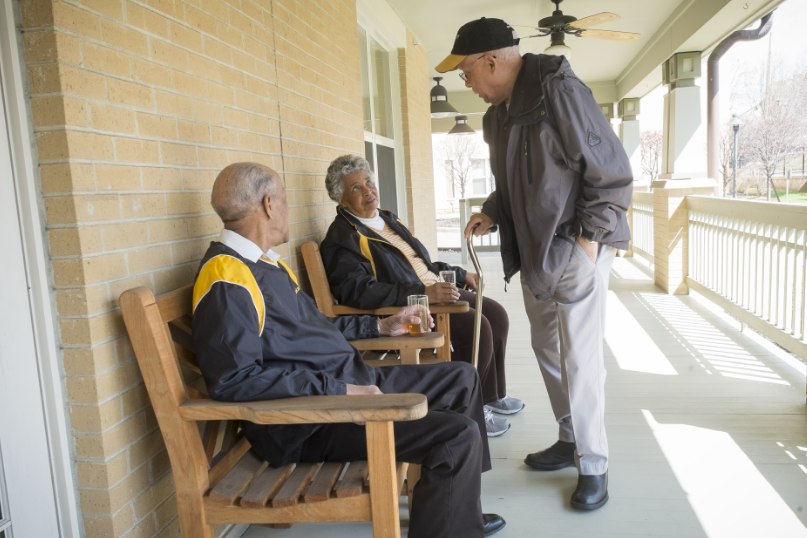 Residents enjoying conversation on the porch.