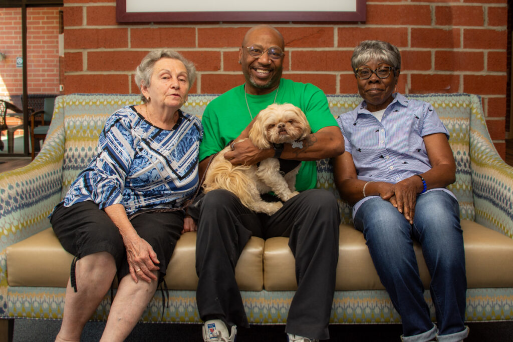 Residents enjoying time together with a dog