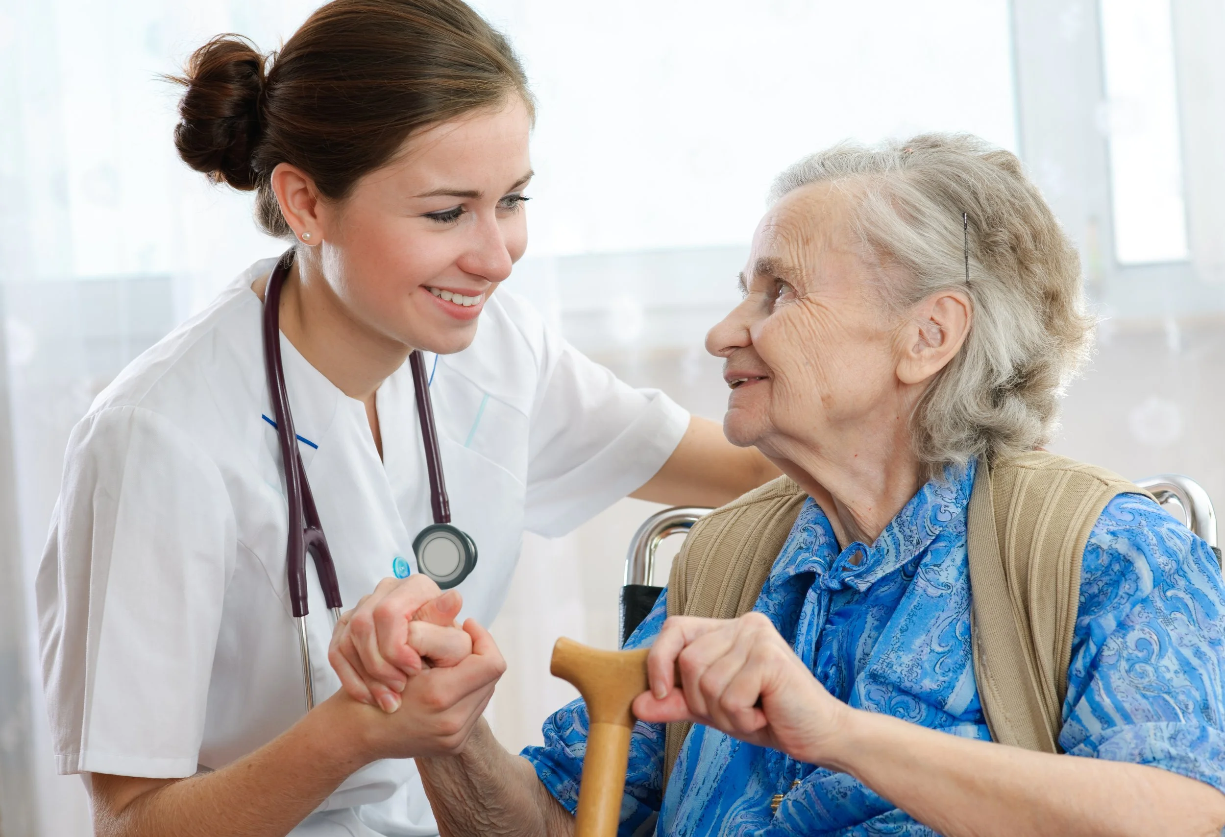 Health worker interacting with an elderly woman