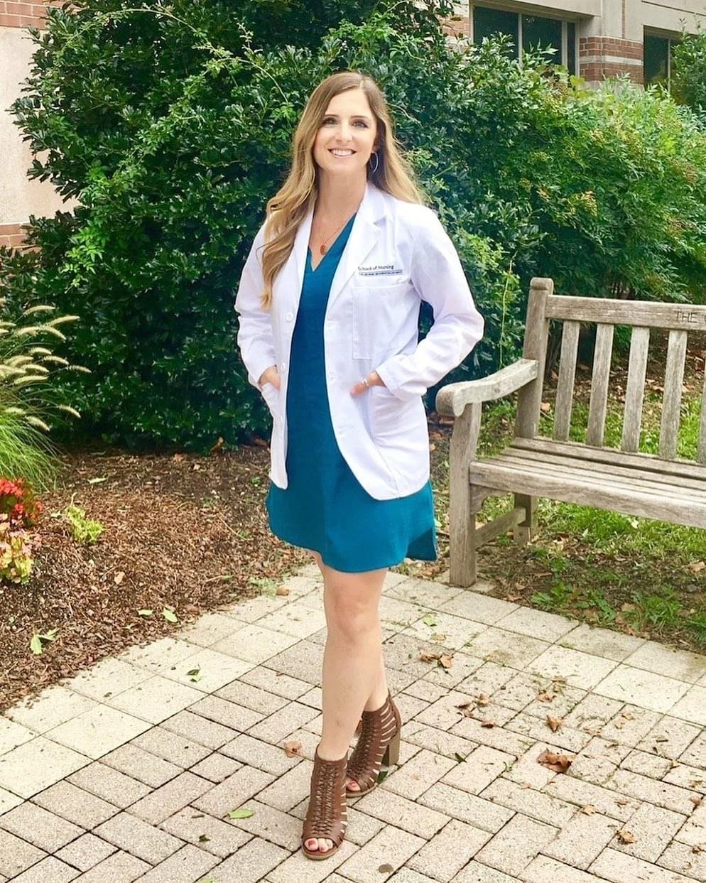 A staff member in a lab coat outdoors