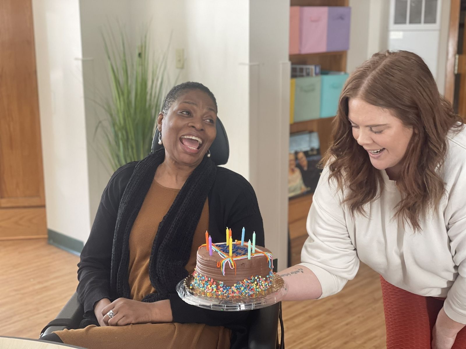 Celebration with a birthday cake and smiling residents