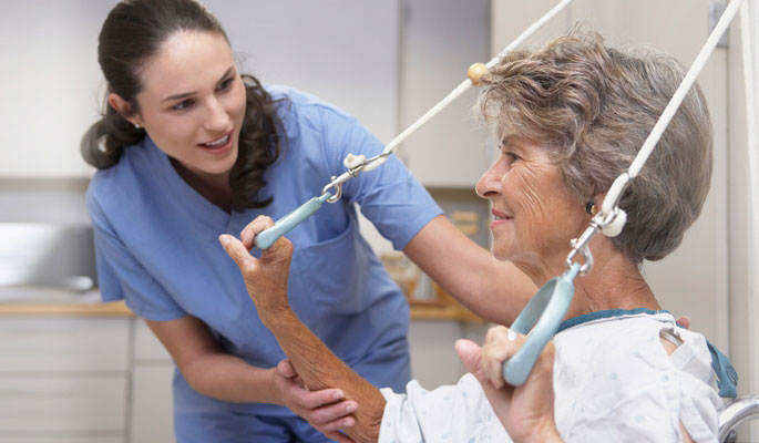 Staff assisting a senior resident in therapy