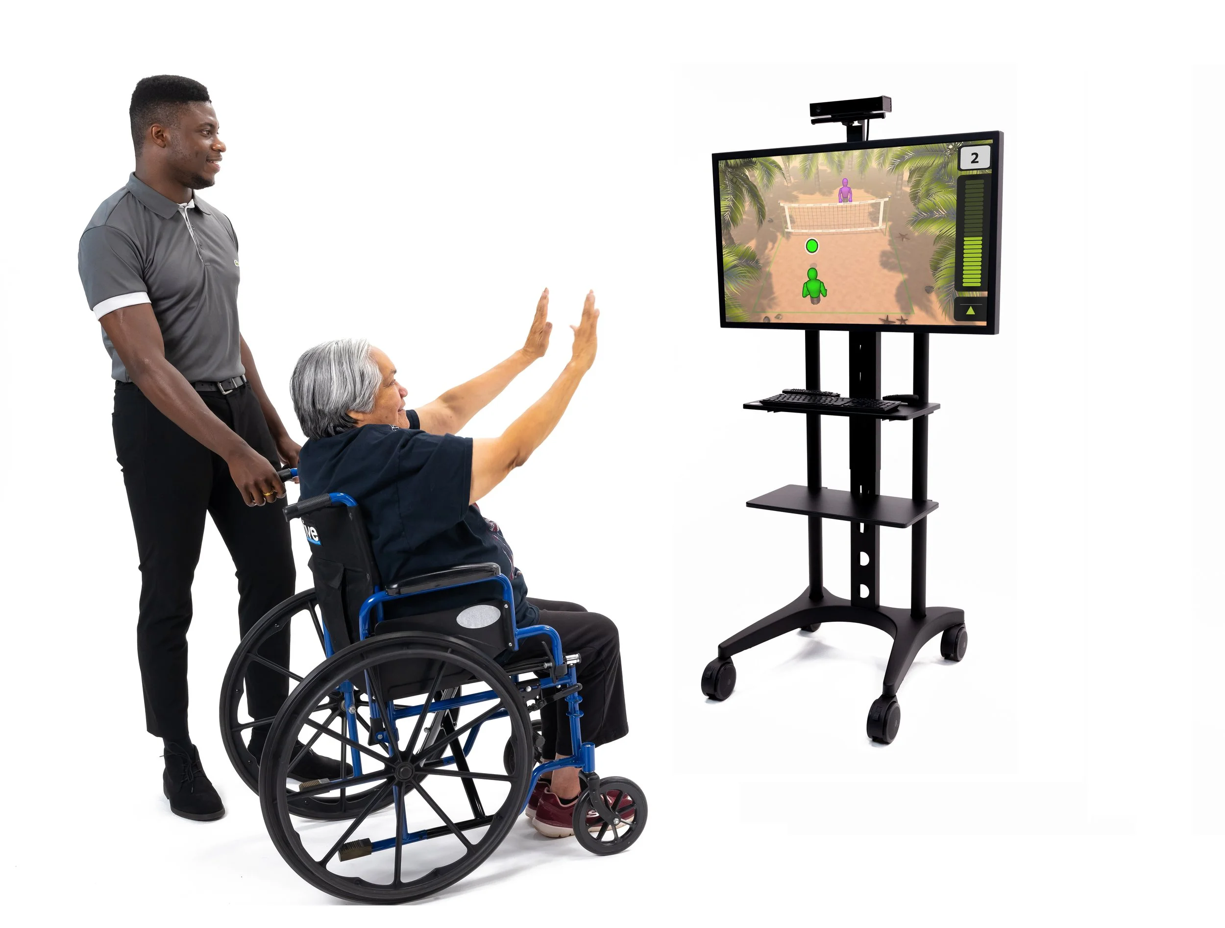 Older adult engaging with staff through a gaming system.