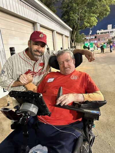 A caregiver with a resident in a wheelchair.
