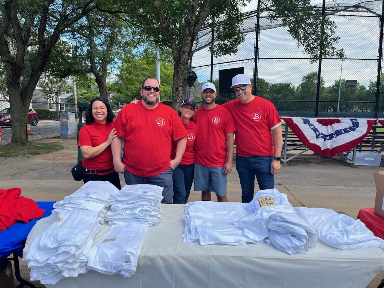 Staff members in matching red shirts at an event.