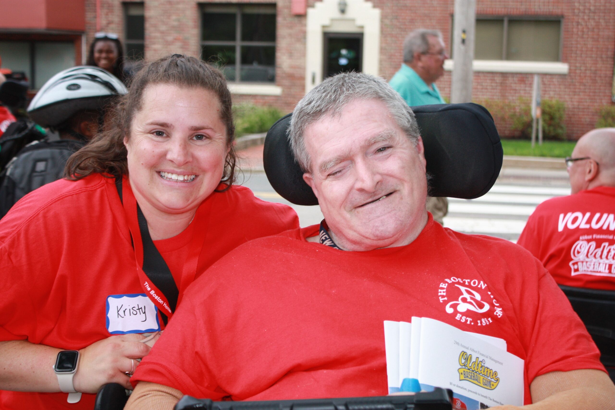 Resident and staff member smiling together