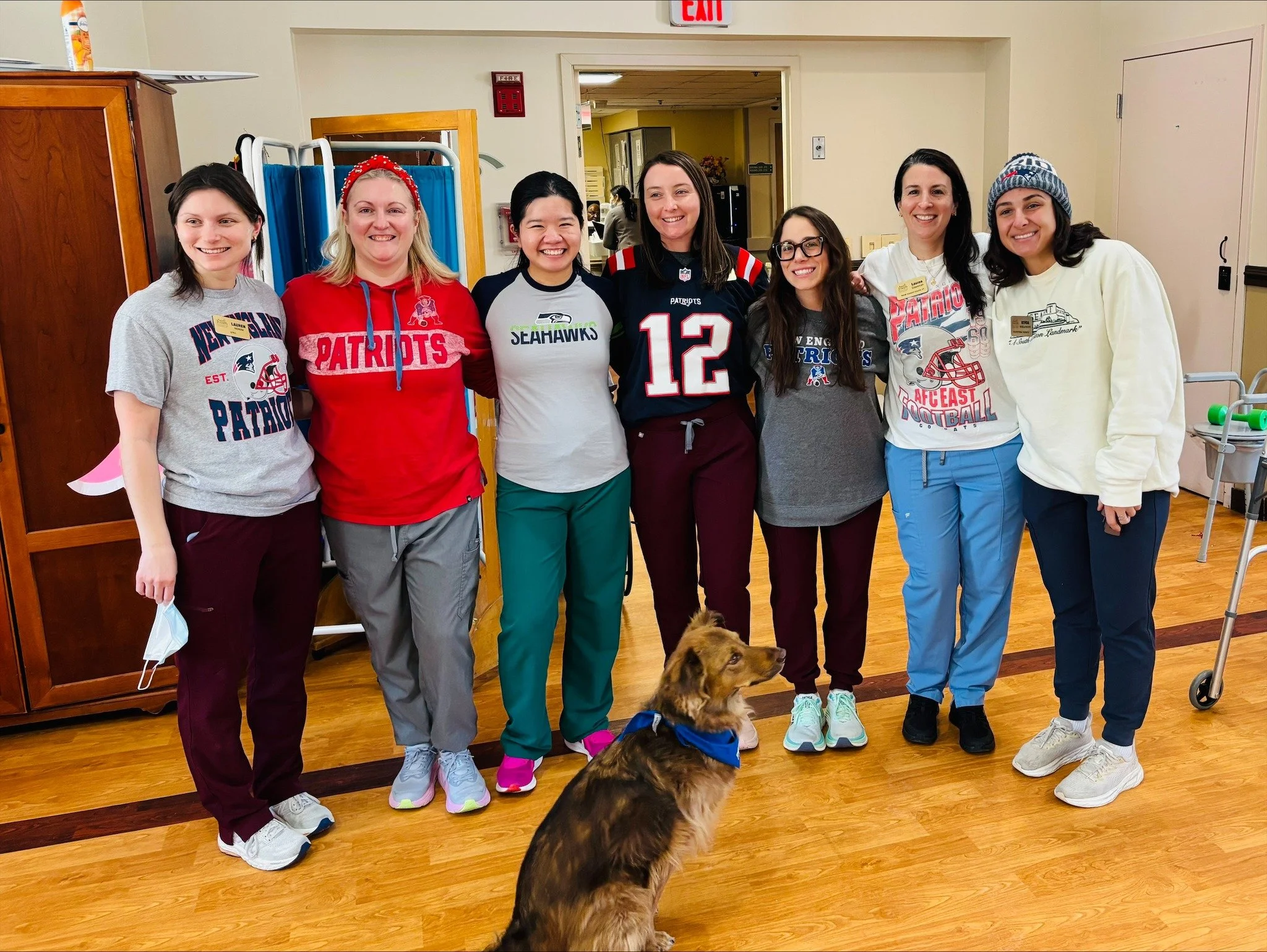 Staff members in themed outfits with a dog