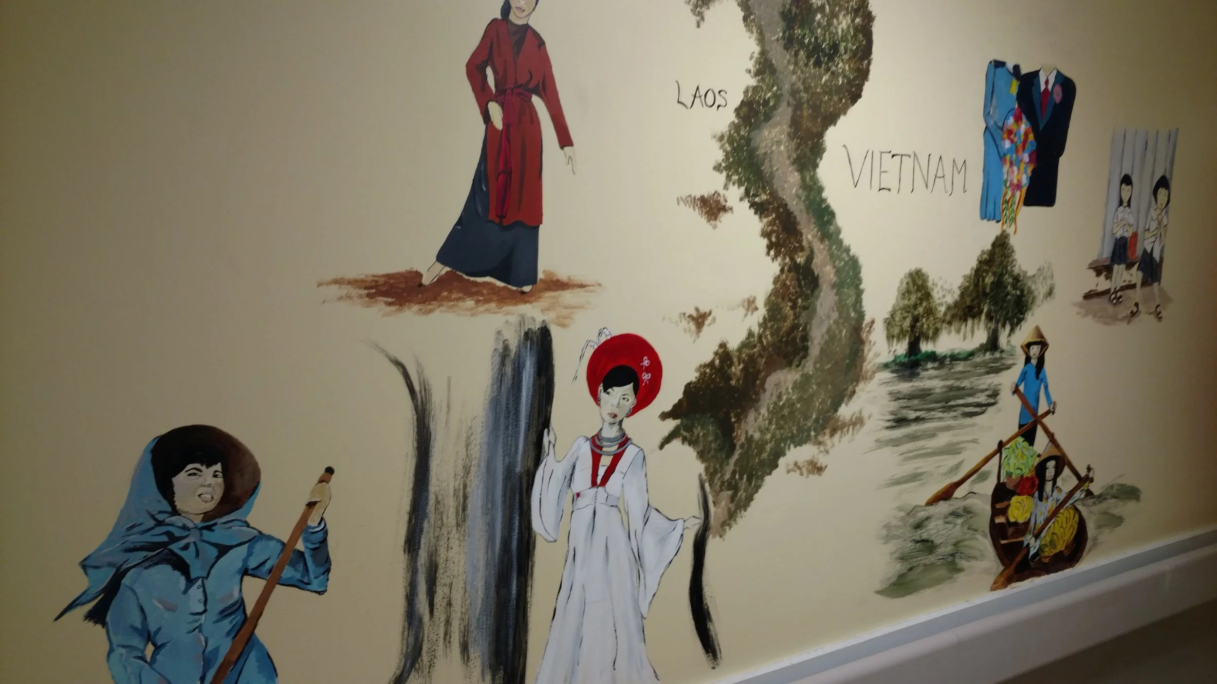 Mural depicting cultural scenes on an interior wall.