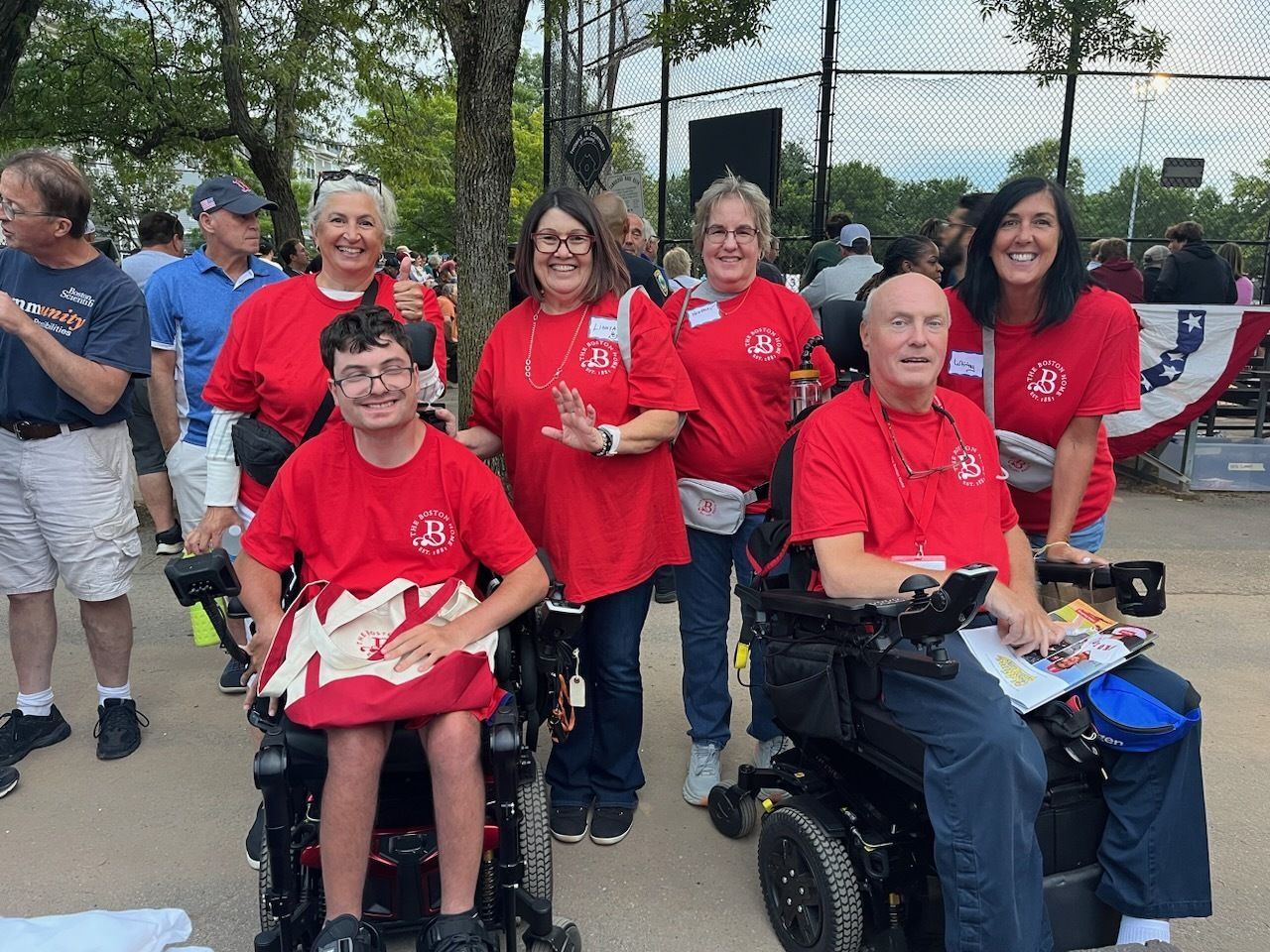 Group of residents and staff in red shirts at an event.