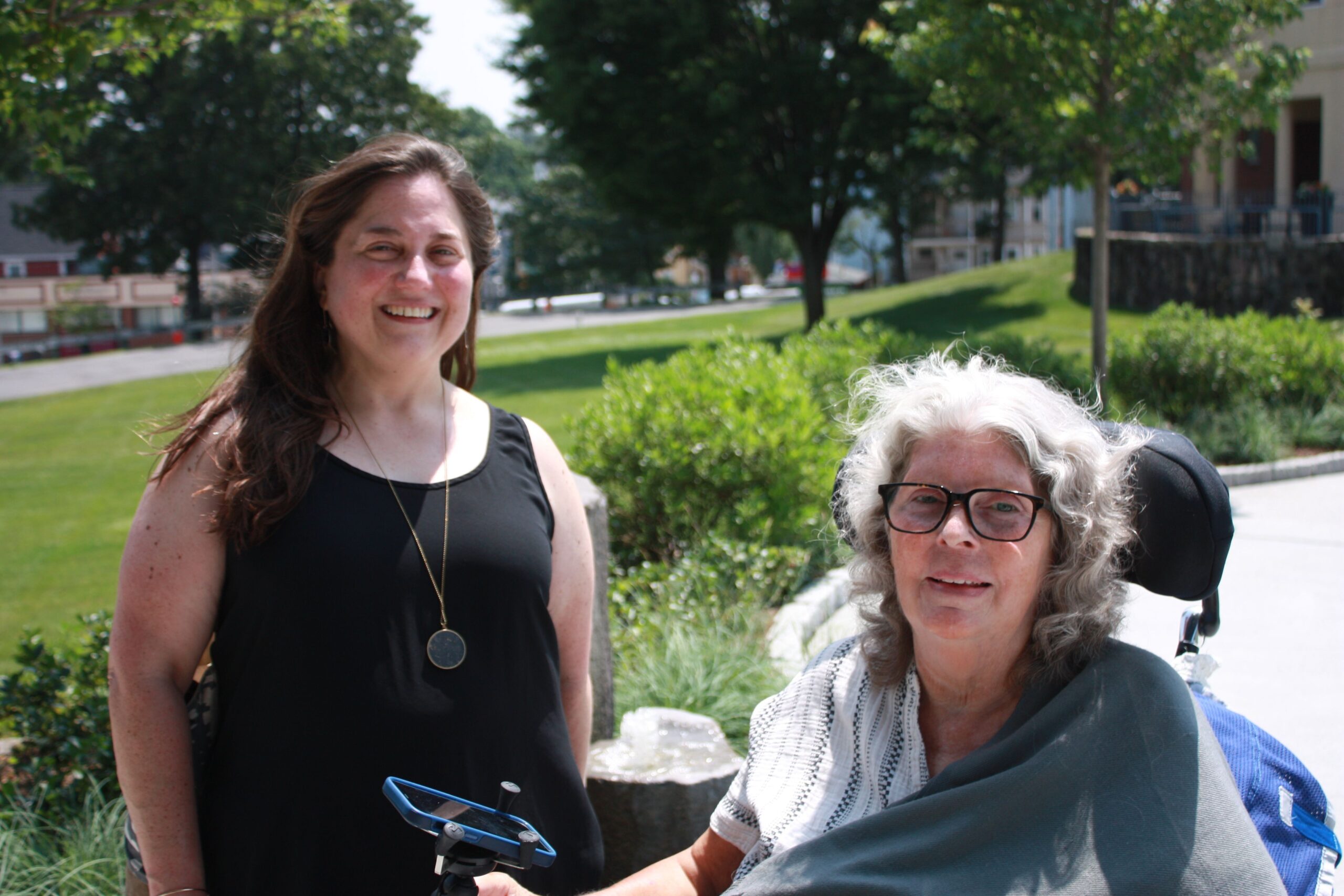 Two women smiling together in a garden