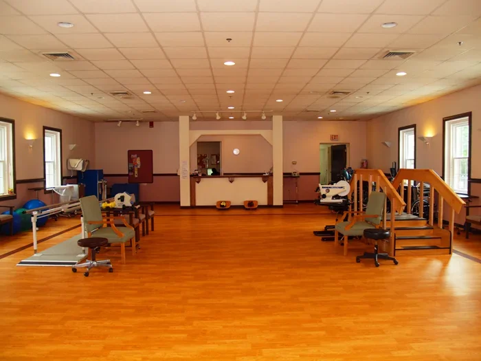 Therapy room with exercise equipment and spacious layout.