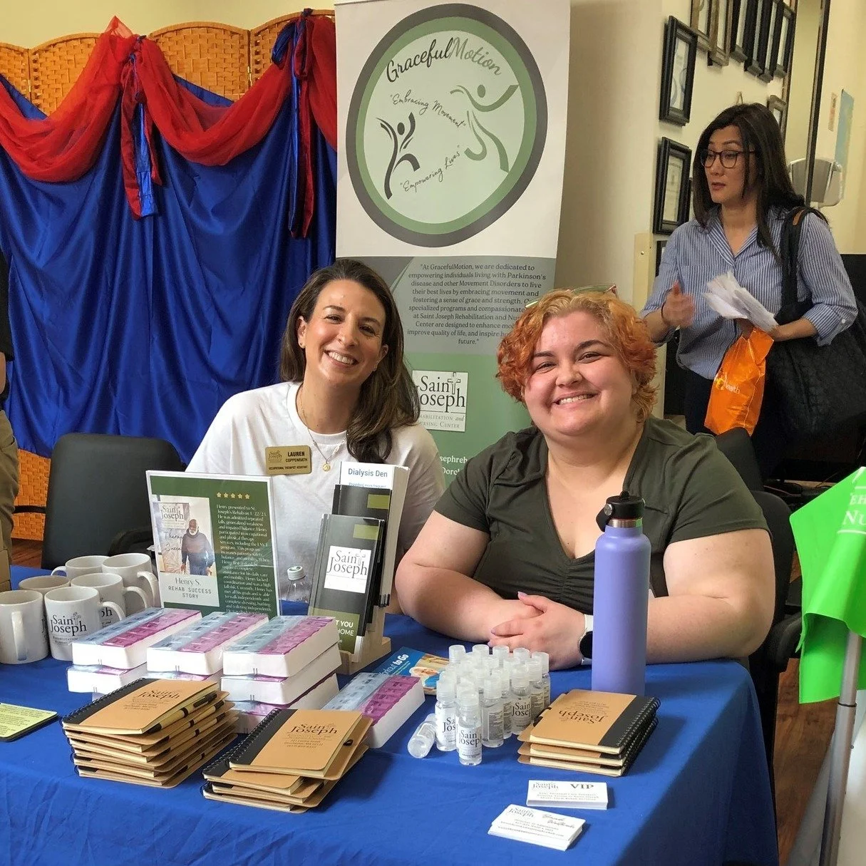 Two staff members at a promotional table