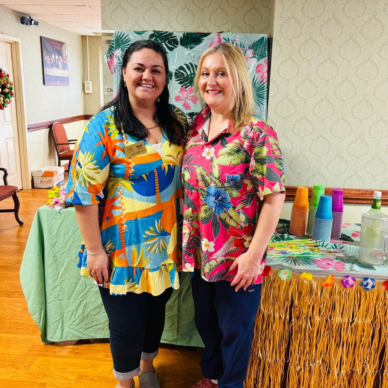Two staff members in festive attire at a celebration
