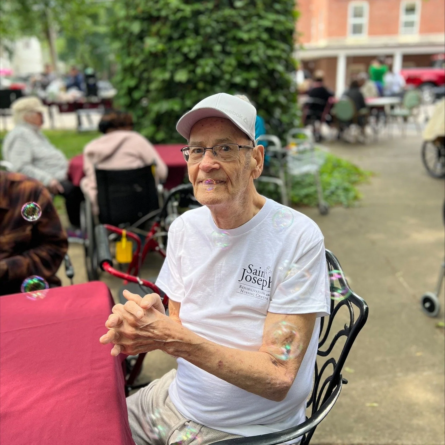 Senior resident enjoying outdoor bubbles at the facility