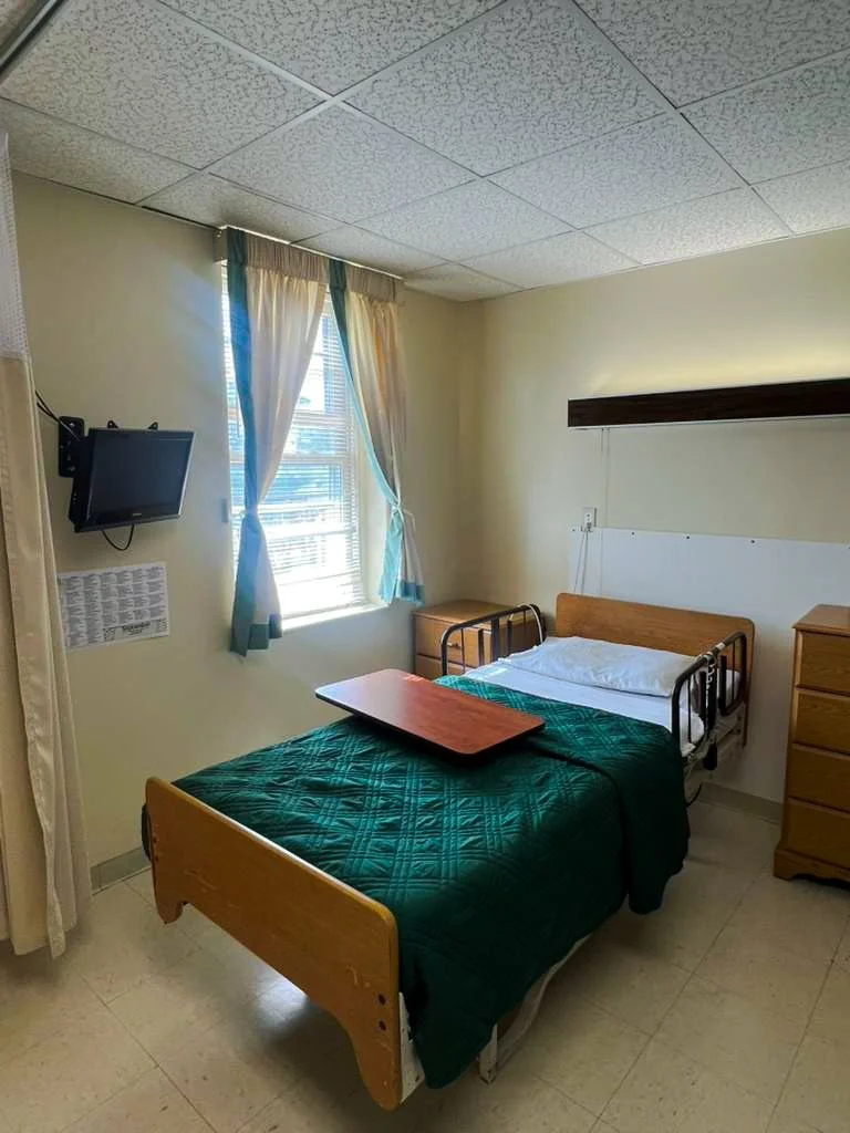 Private resident room with a bed and TV.