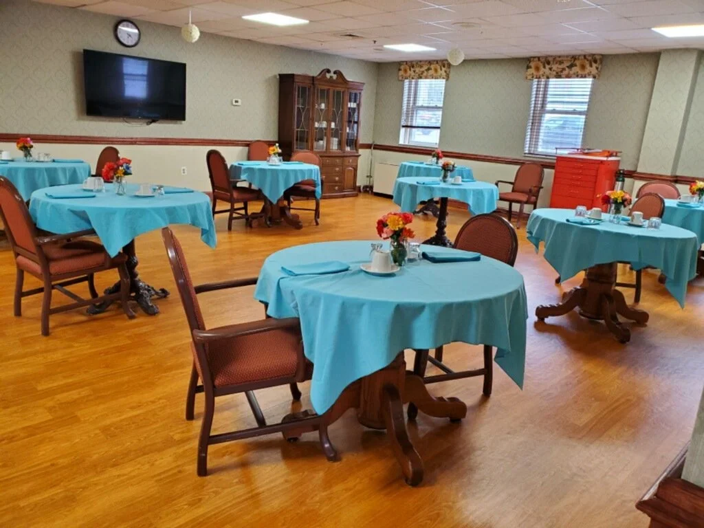 Dining area with tables and flowers set for meals