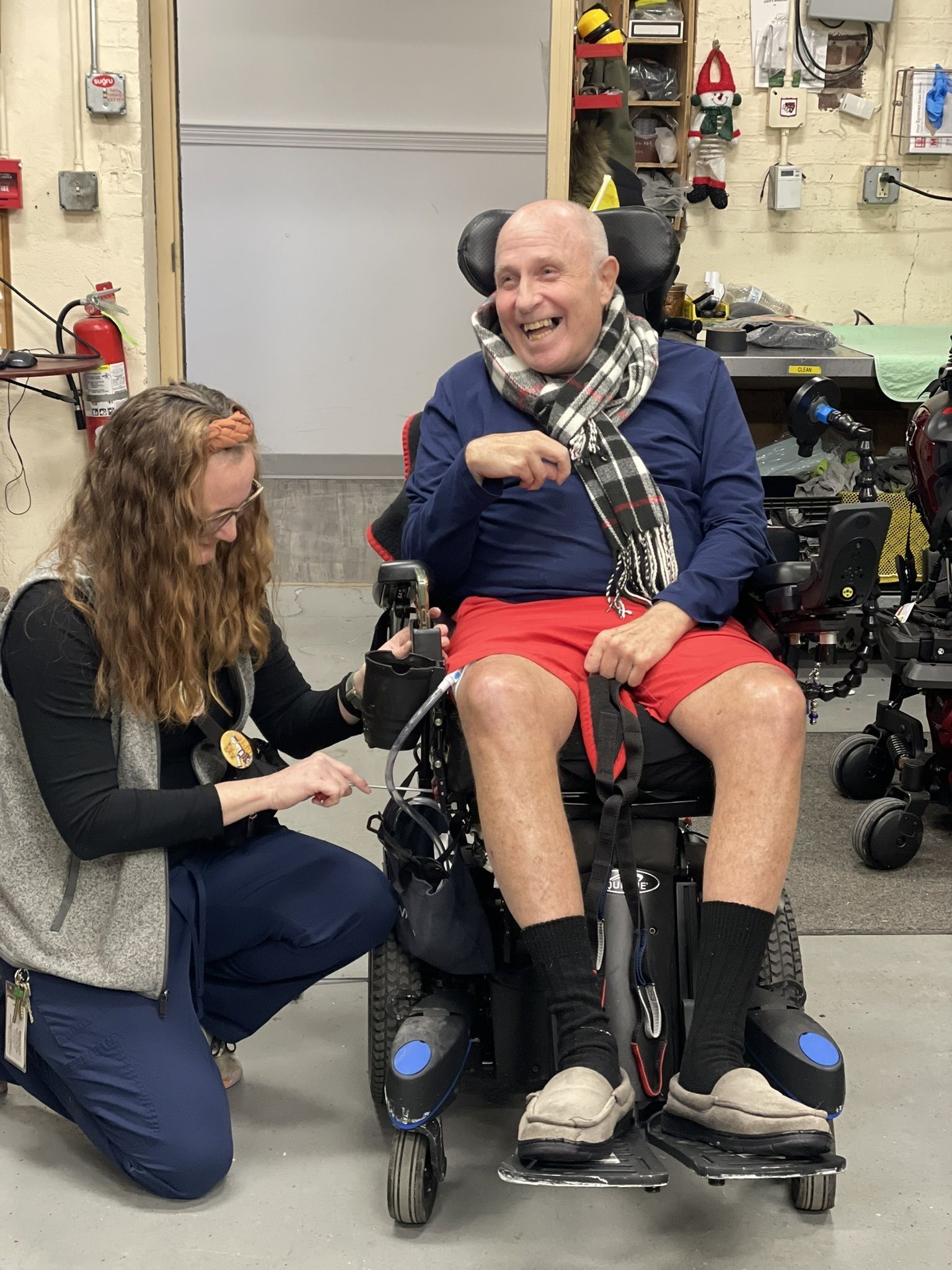 Resident interacting with staff in a workshop setting.