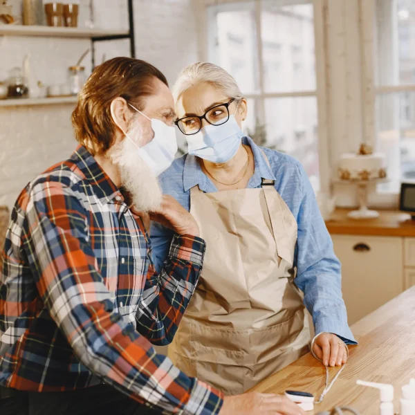 Two seniors engaging in a friendly interaction