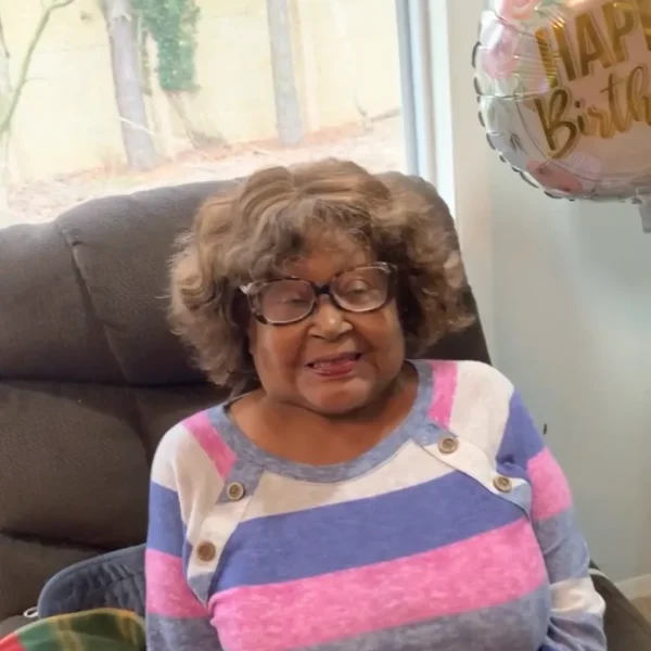 Resident celebrating a birthday with a balloon.