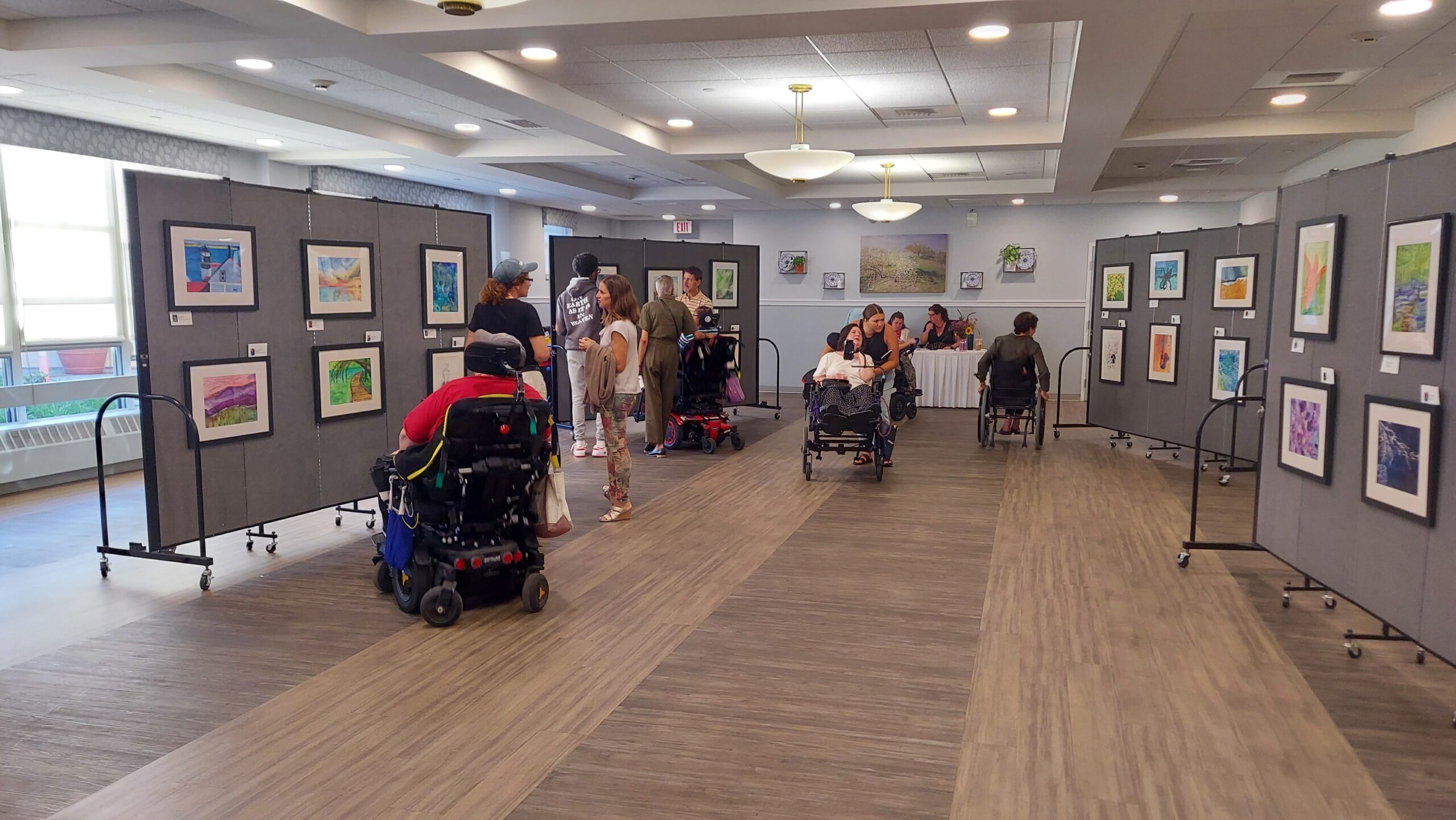 Art exhibition featuring residents' artwork in a common area.