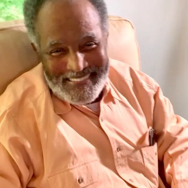 Smiling resident in a cozy chair