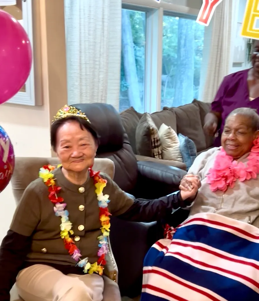 Residents celebrating with decorations and smiles.