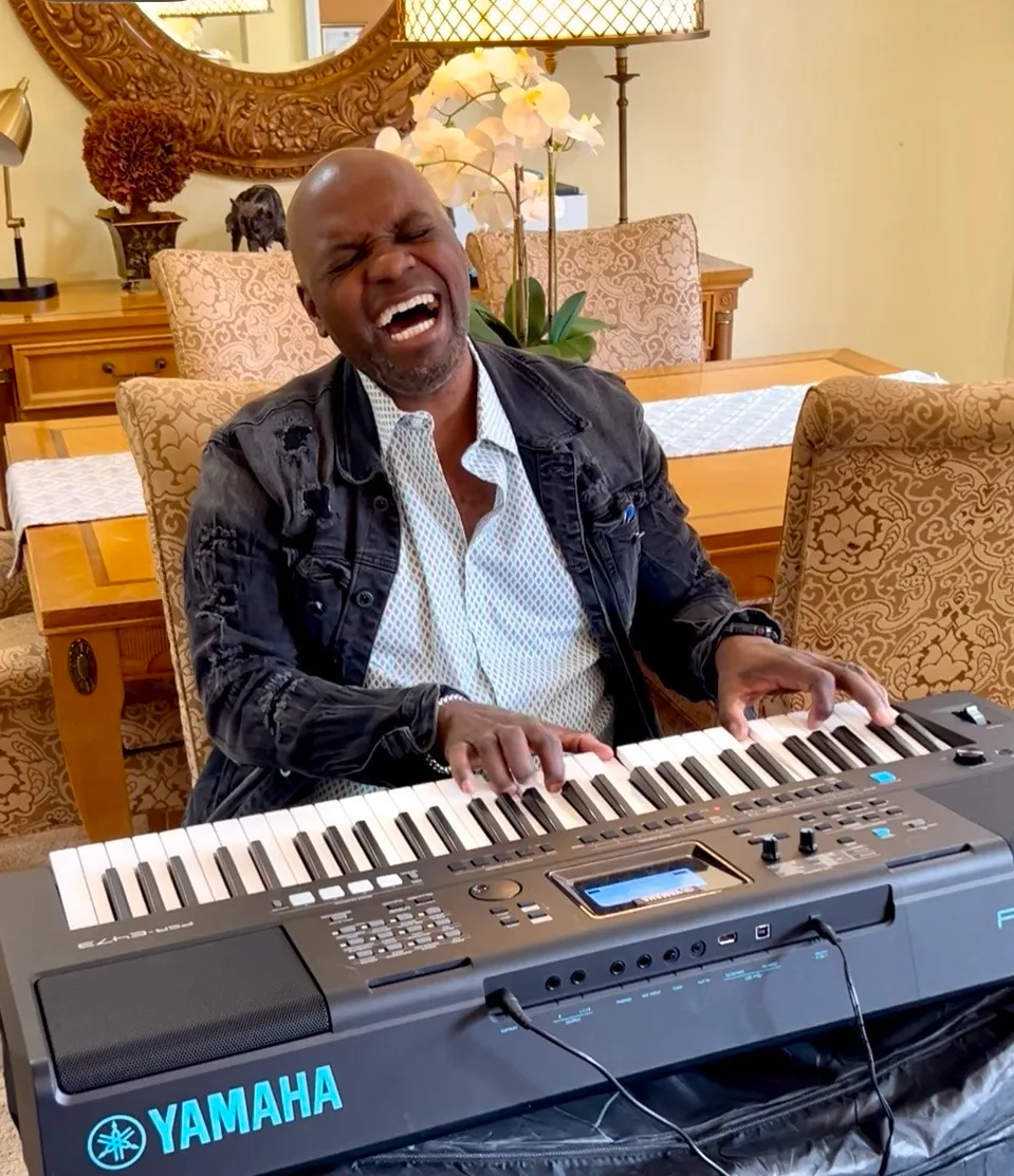 Musician performing joyfully at a piano