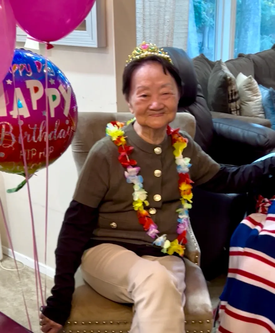 Senior woman celebrating birthday with decorations