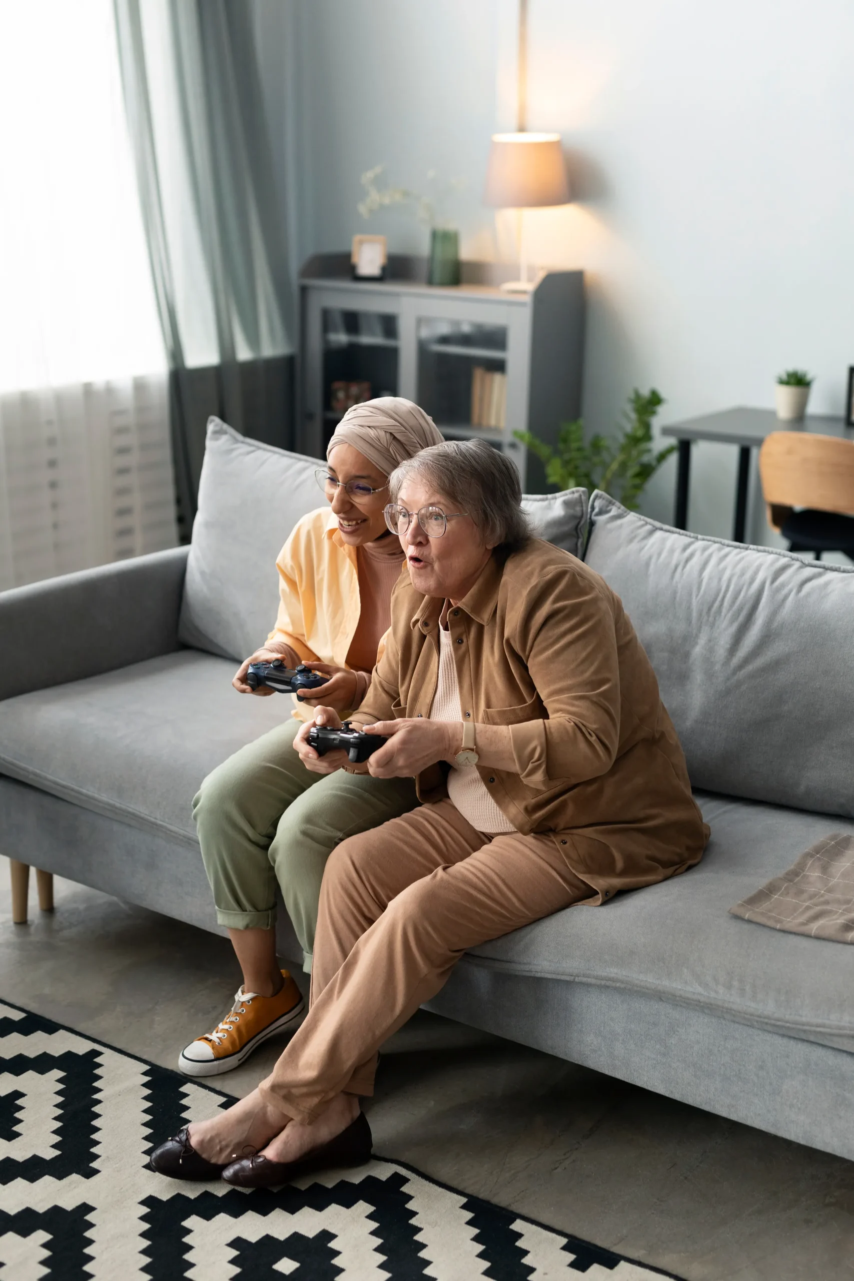 Two seniors enjoying a video game session.