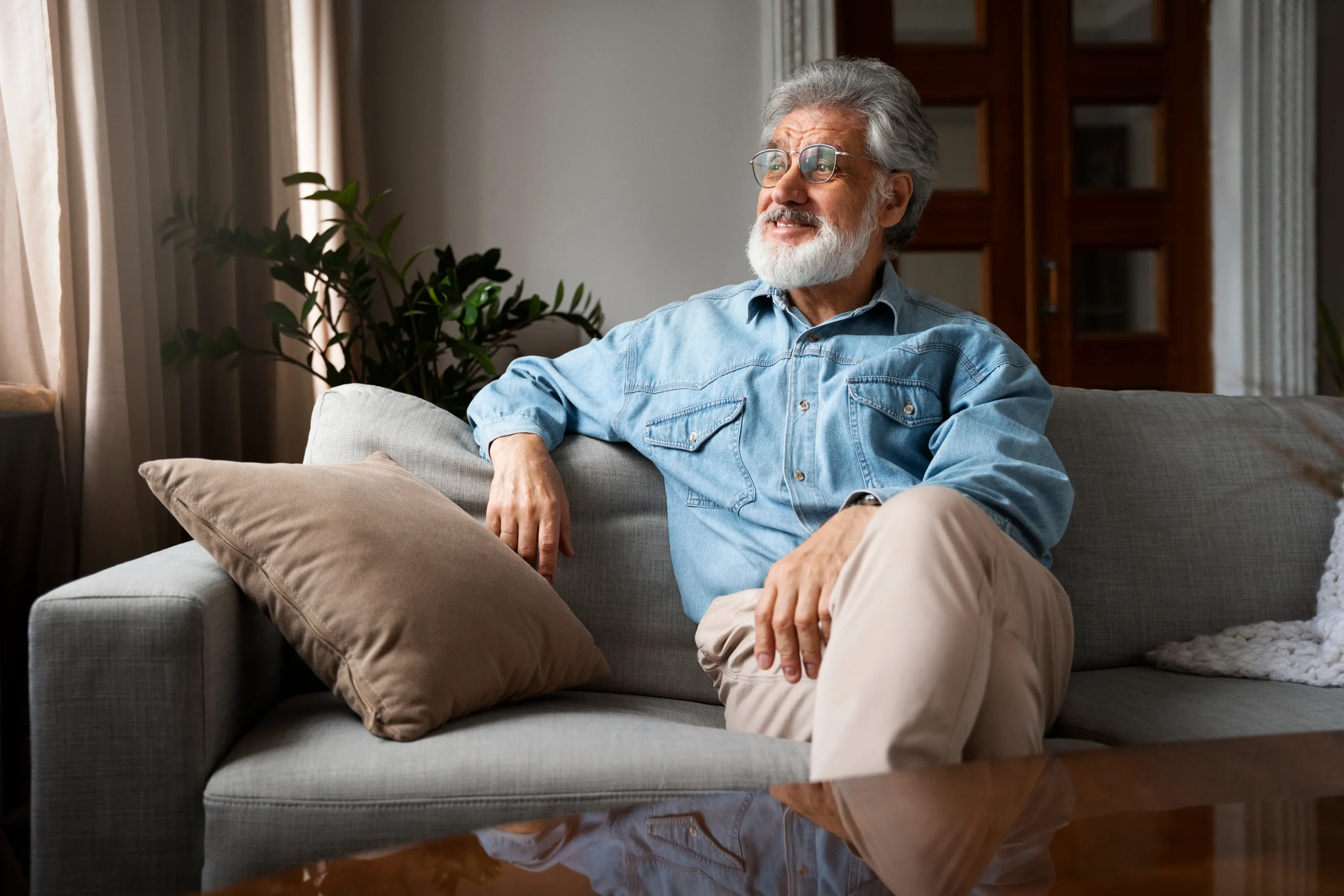 Senior man relaxing on couch in a cozy interior
