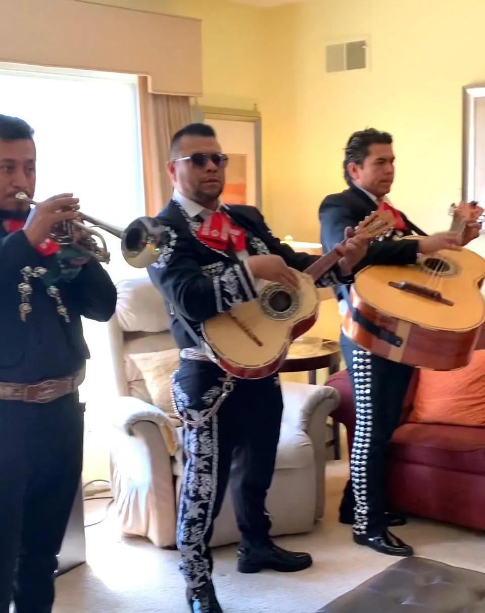 Musicians performing in a cozy living area.