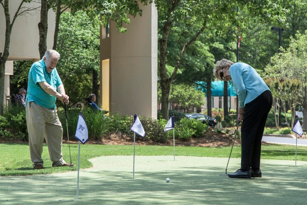 Residents playing golf on a putting green