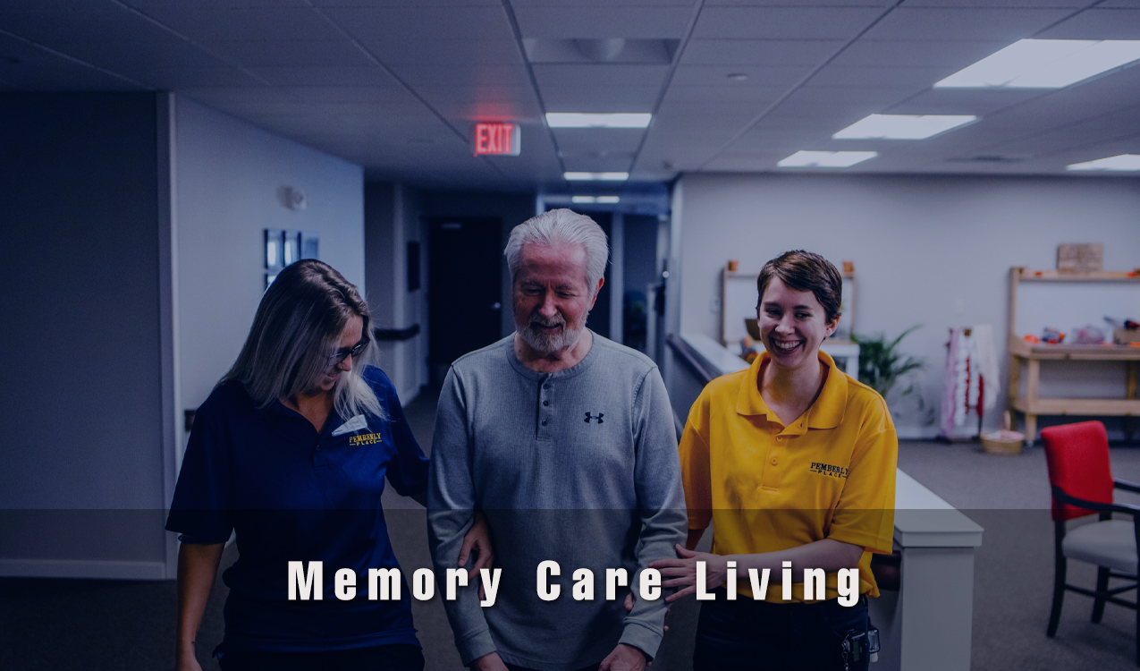 Staff assisting a resident in a memory care setting.