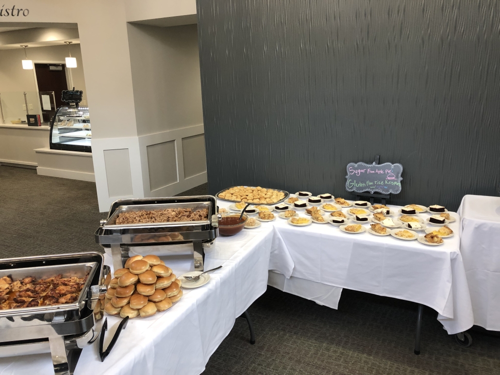 Dining area with a buffet setup and desserts.