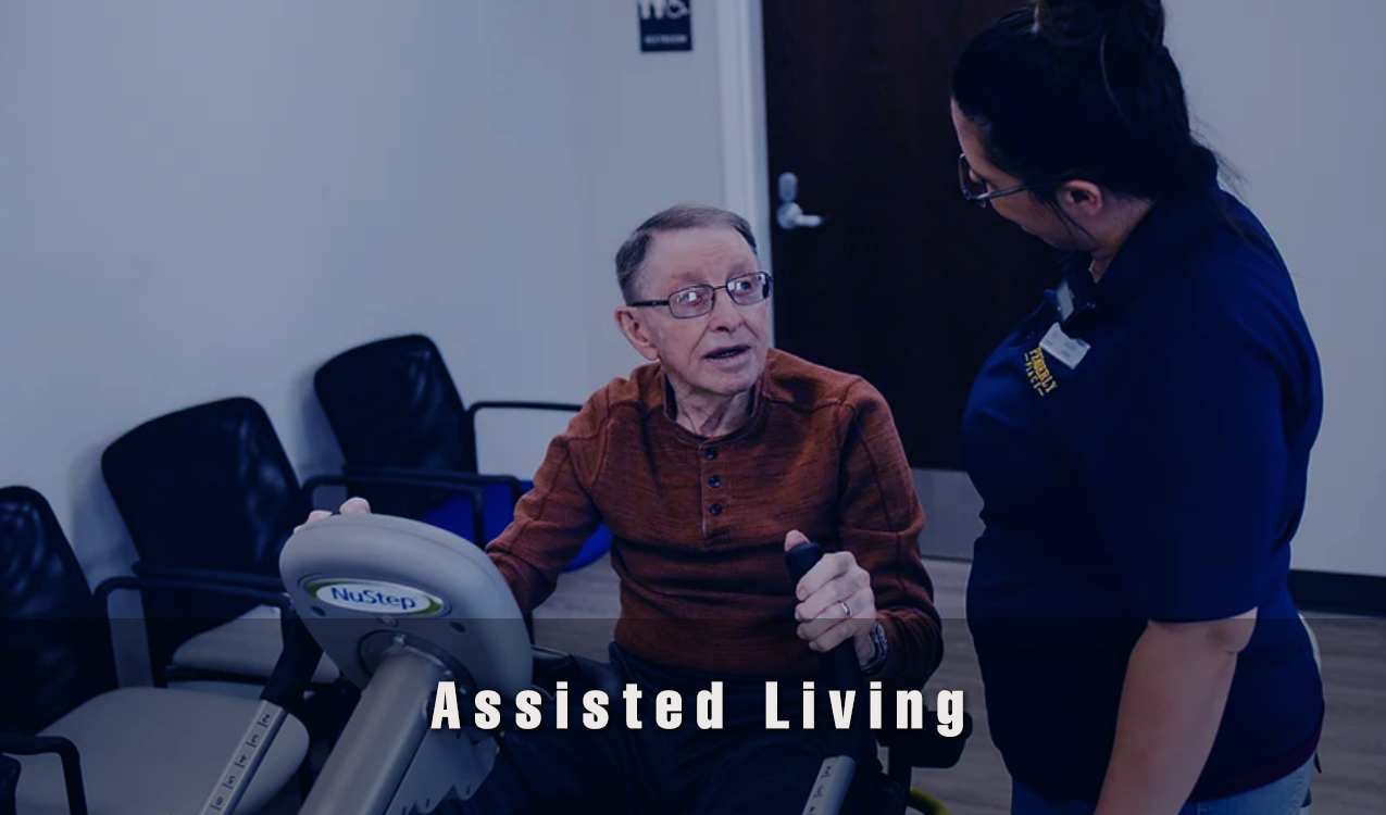 Resident engaging in exercise with staff assistance.