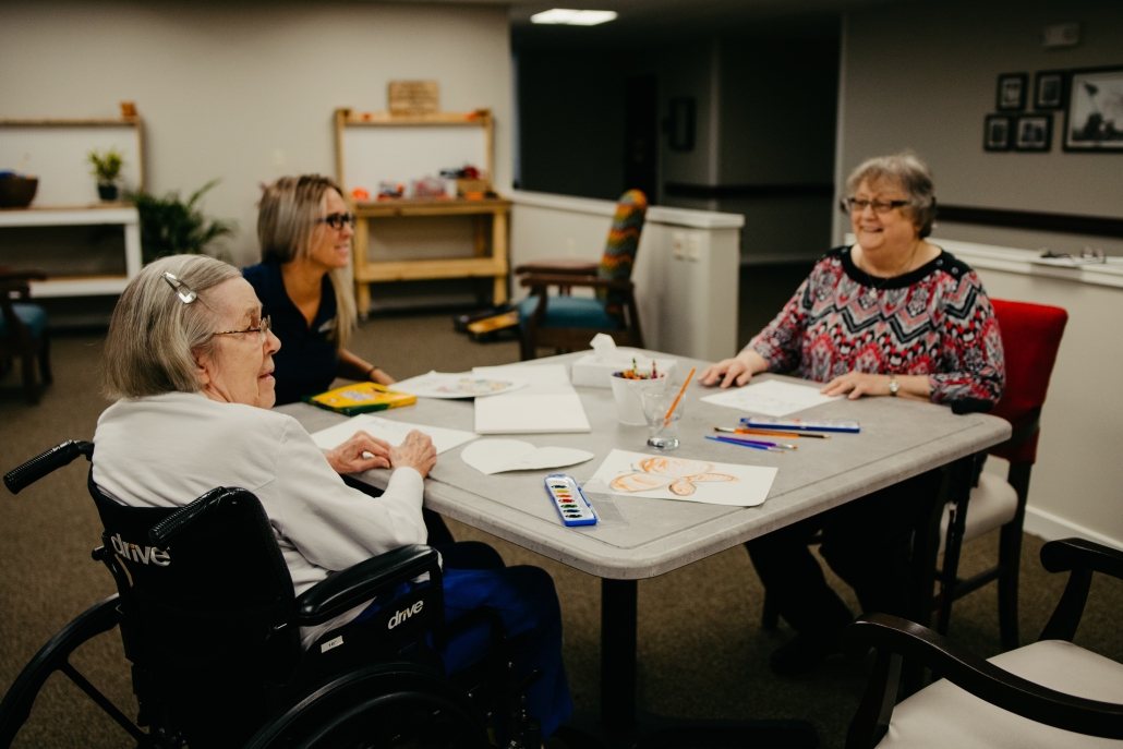 Residents and staff engaged in an art activity.