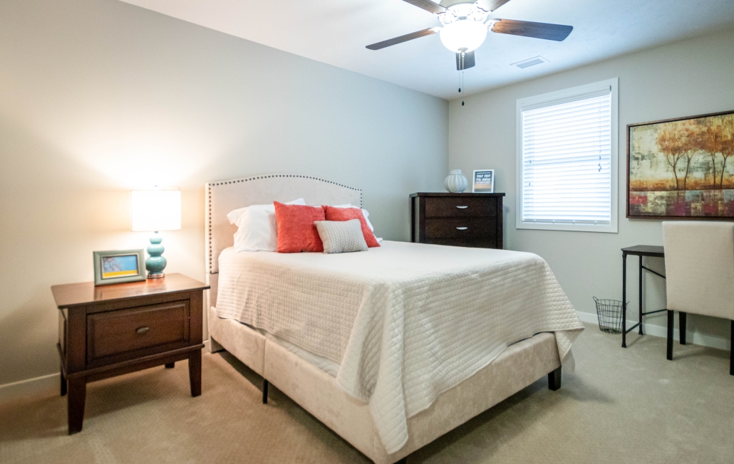 Cozy resident room with bed and furnishings.