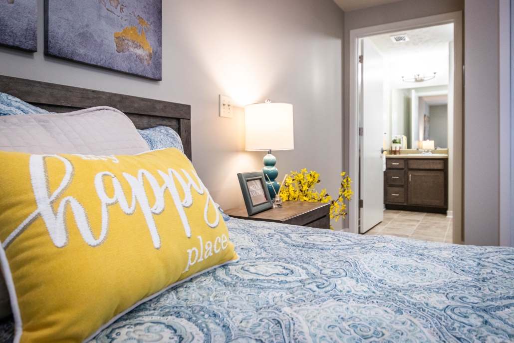 Cozy bedroom with decorative pillow and lamp