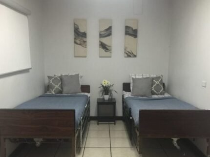 A shared bedroom with two beds