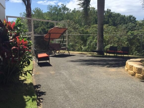 Outdoor relaxation area with seating and greenery.