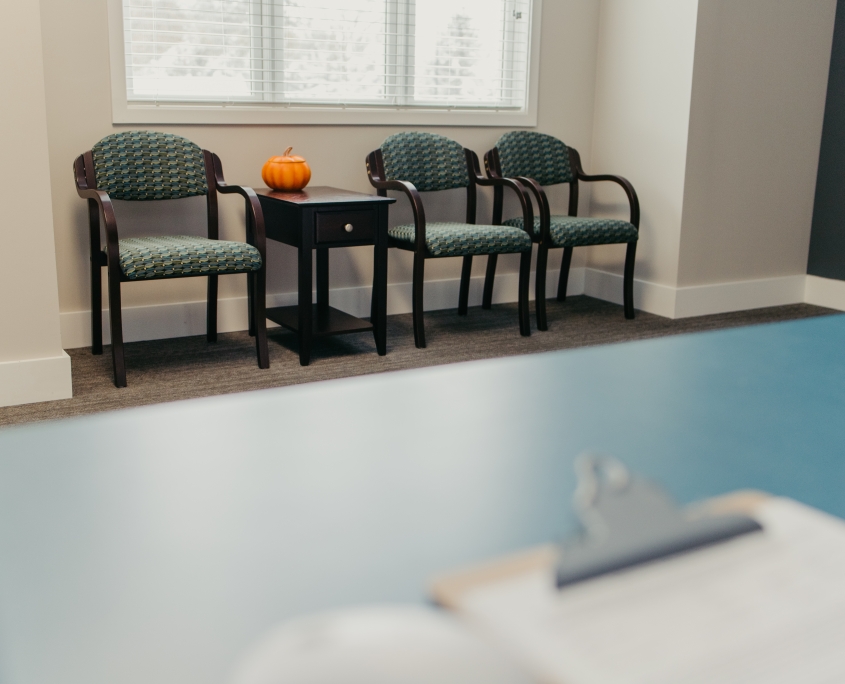 Chairs with a small pumpkin on a table