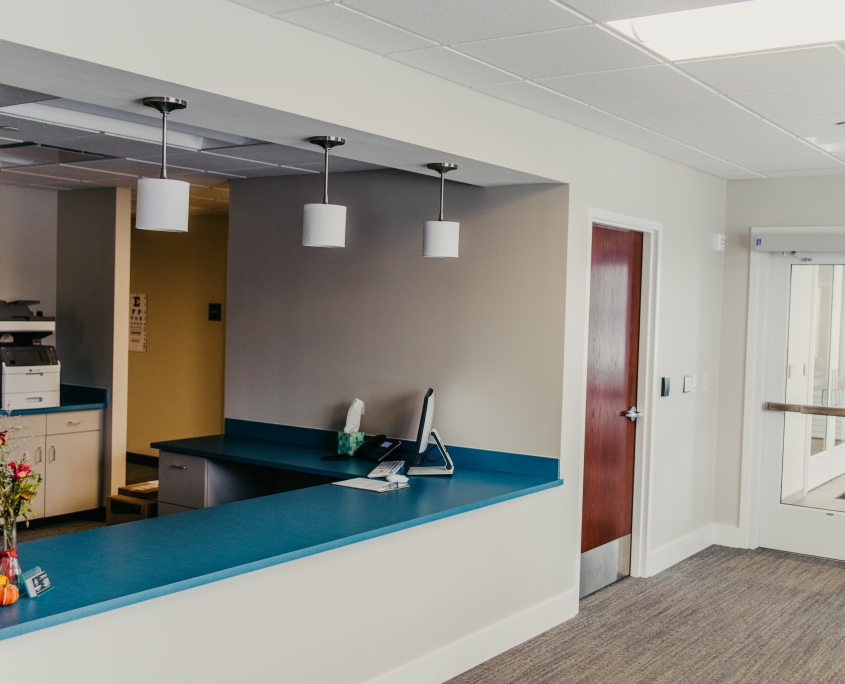 Reception area with blue counter and light fixtures