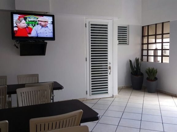 Interior common area with a television and plants