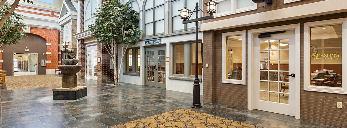 Interior hallway with seating and fountain feature.