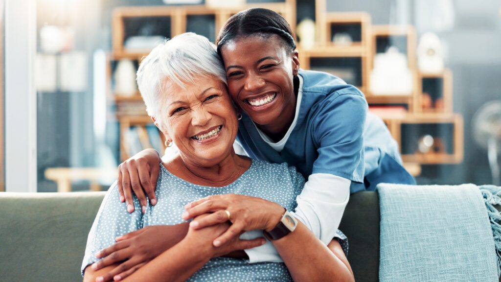 Smiling caregiver and resident sharing a joyful moment.
