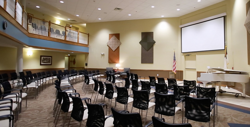 Common area setup for an event with chairs and a piano.